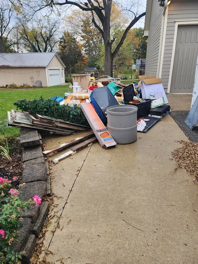 Dumpster being loaded with debris for Roofing Dumpster Rental in East Marlborough